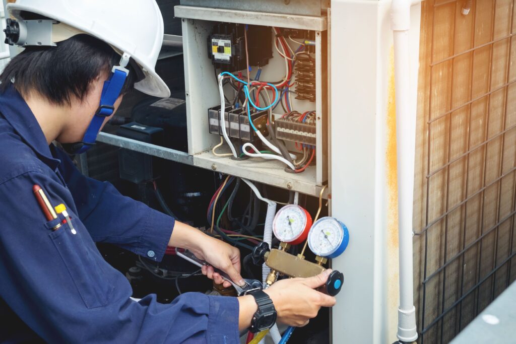 A technician performing a service on an air conditioning system.